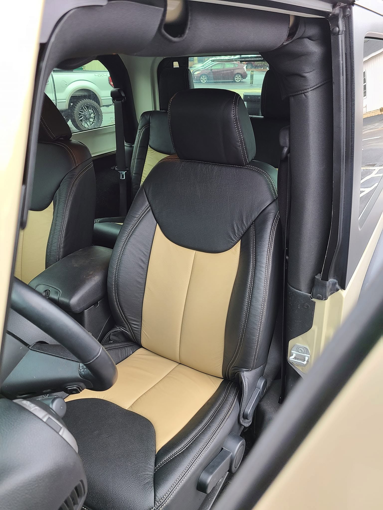 Two-tone black and tan leather Jeep front seat