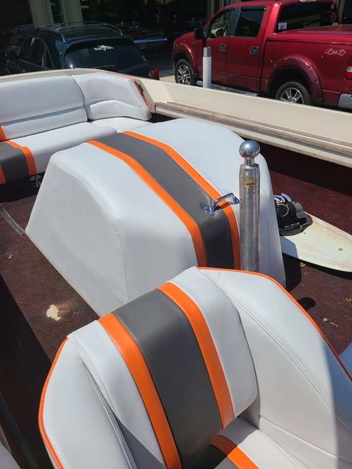Sport boat lounge seating in grey marine vinyl with an orange accent stripe